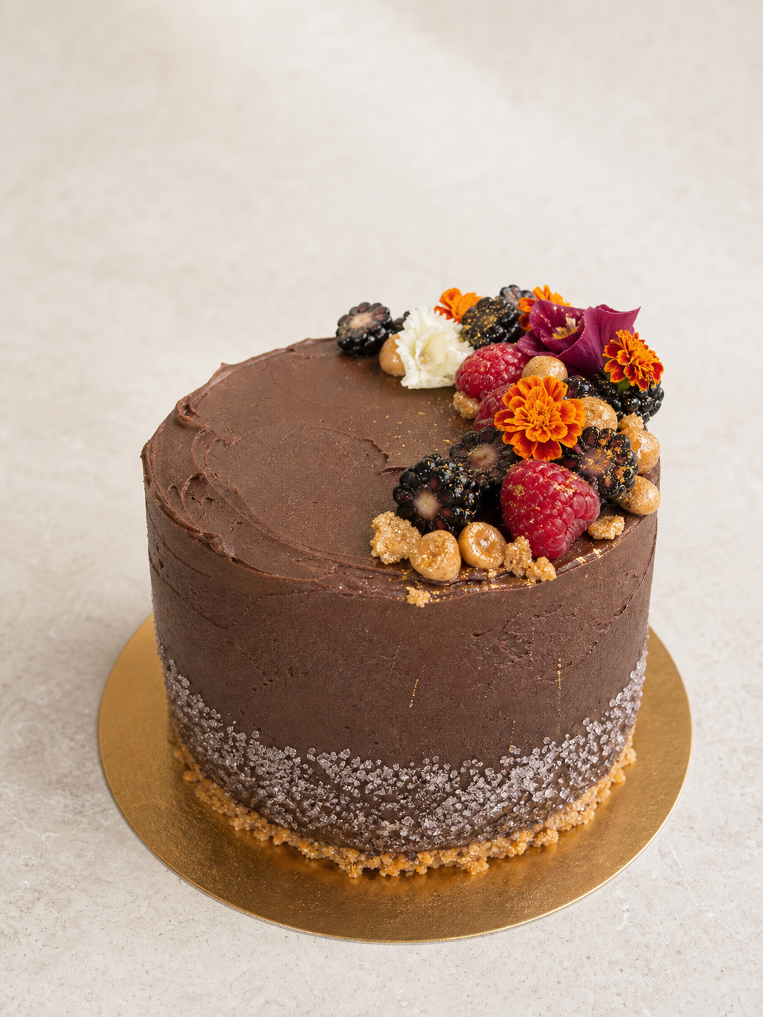 Chocolate cake with berries and edible flowers