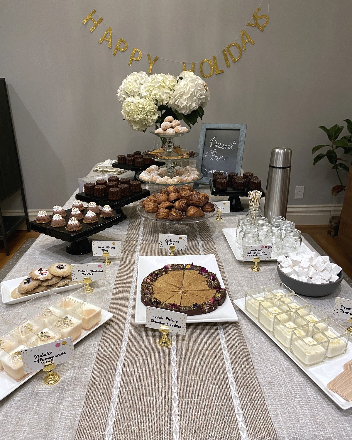 Holiday dessert table with cookies, pastries, and small bites