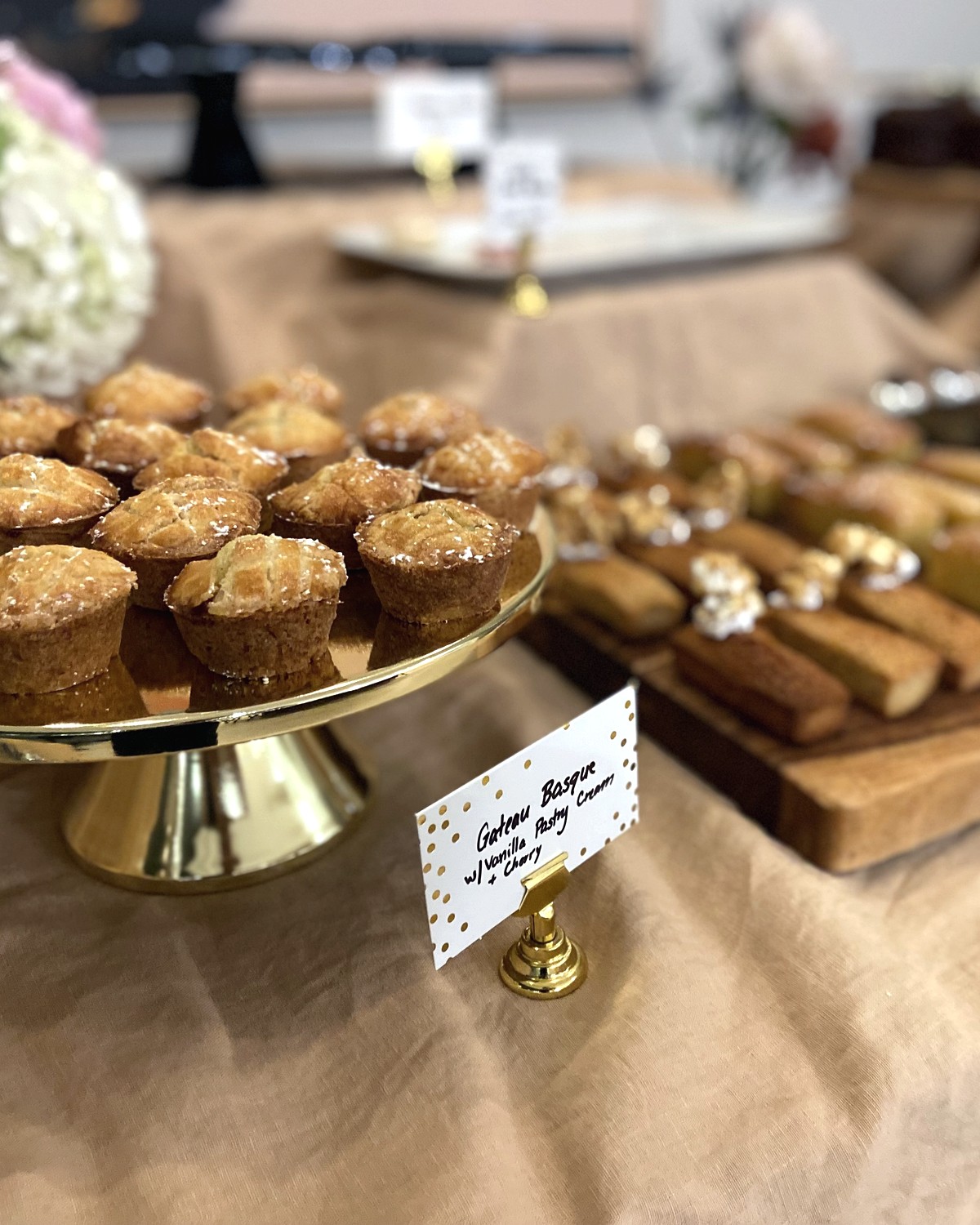 Dessert table detail with pastries on a raised stand